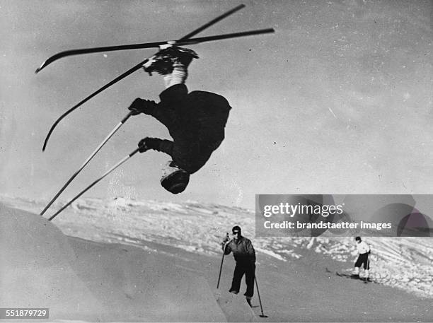 Somersault on skis through A R Little - captain of the Dartmouth College ski team - in the ski resort of Lac-Beauport. 20th January 1938. Photograph.