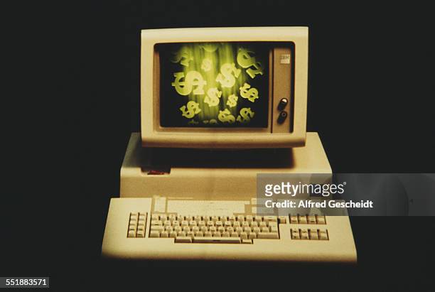 Dollar signs on the monitor of an IBM computer, 1983.