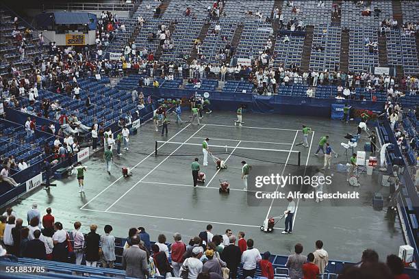 Rain on the court at the National Tennis Center in Flushing Meadows Park, Queens, New York City, 1986.