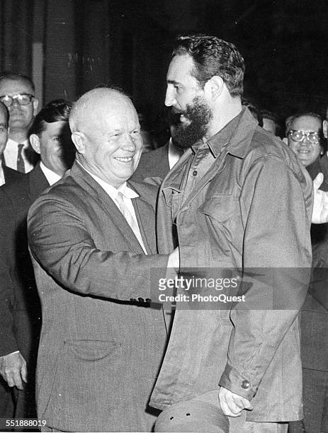 Russian politician and Premier Nikita Krushchev moves to hug Cuban Premier Fidel Castro as the latter arrives for dinner at the Soviet legation, New...