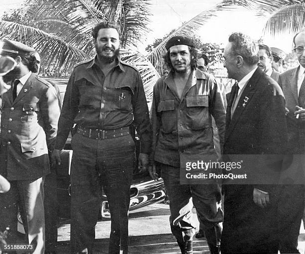 From left, Cuban revolutionaries, Premier Fidel Castro and National Bank President Ernesto Che Guevara , share a laugh with Russian politician and...