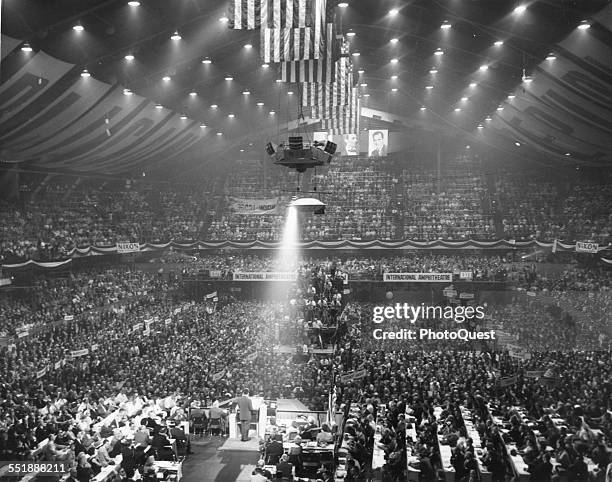 Elevated view of the crowded International Amphitheatre during the Republican National Convention, Chicago, Illinois, 1960. Hanging in the background...