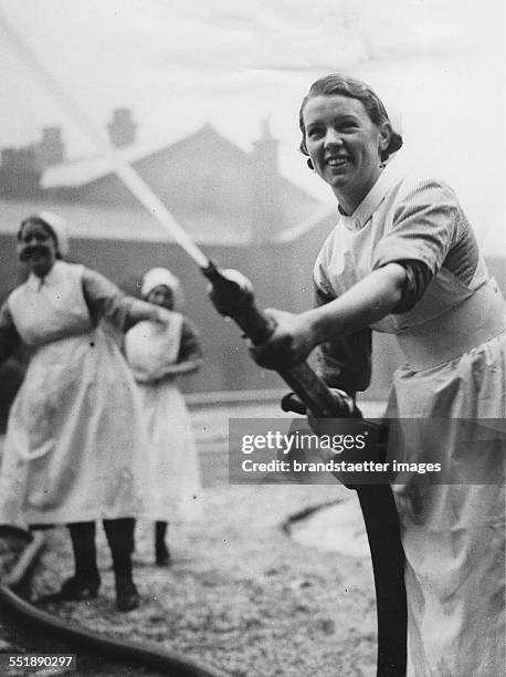 Nurses of Barnsley Municipal Hospital at a fire drill. 18th February 1936. Photograph.