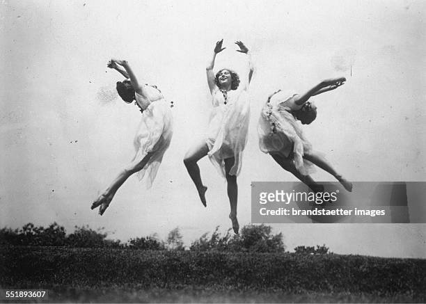 Three female dancers from Los Angeles dancing on a meadow. 23th July 1929. Photograph.