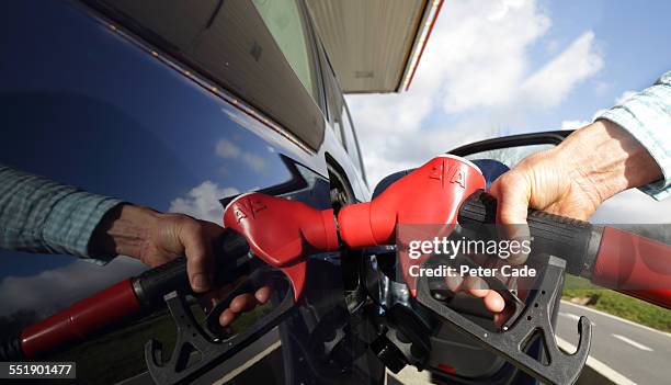 close up ,  refuelling car . - only mature men fotografías e imágenes de stock