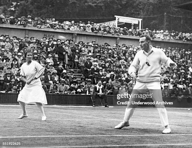 Americans Elizabeth Ryan and Frank Hunter playing against the British team in the Lawn Tennis Championships at Wimbledon, London, England, 1927. They...