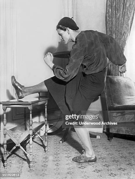 Mildred 'Babe' Didrikson, star athlete from Beaumont, Texas, hurdles over a table in her room at the Biltmore Hotel, New York, New York, January 4,...