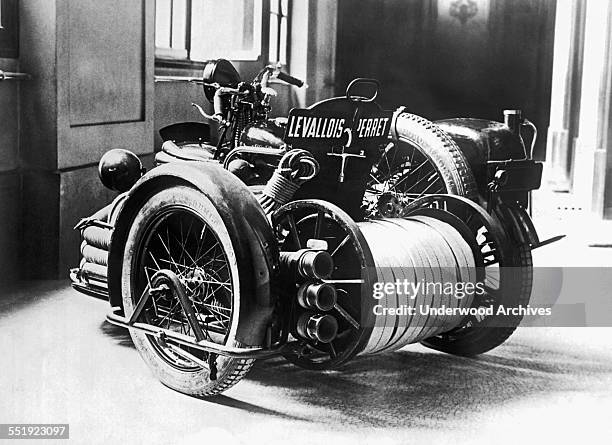 New motorcycle fire engine has made its debut in Paris, Paris, France, circa 1930. It carries 400 feet of hose, two people, and a 9HP motor.