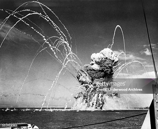 An American cargo ship exploding after being hit by Nazi dive bombers in an air raid on a convoy during the invasion of Sicily by Allied Forces,...