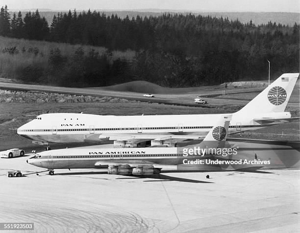The first Boeing 747 rolls off the production line with Pan Am markings and dwarves a Pan Am Boeing 707-321B sitting in the foreground, Everett,...