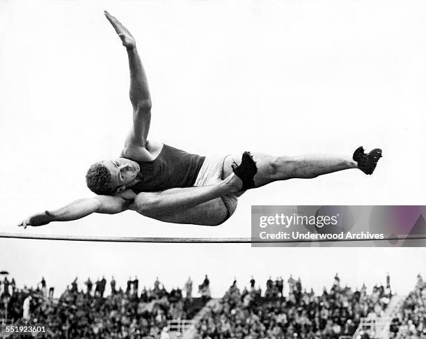 Olympic bronze medal winner Delos Thurber of the University of Southern California makes his wining leap in the high jump of 6 feet, 6 5/8 inches to...