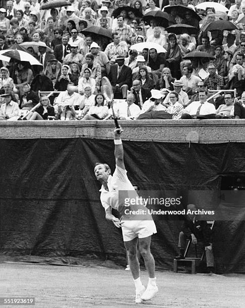 Professional tennis player Rod Laver serves against Arthur Ashe in the semi-finals of the US Open Tennis Championship, Forest Hills, New York,...