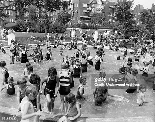 Children swimming to try and beat the heat, Chicago, Illinois, July 21, 1930.