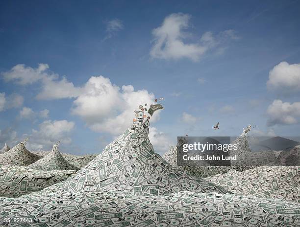financial abundance in a sea of money - capitalismo fotografías e imágenes de stock