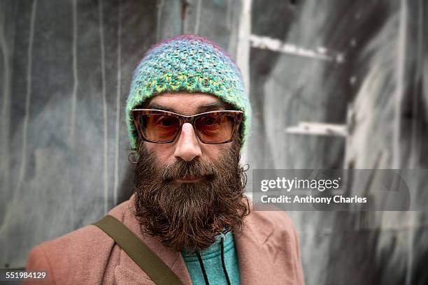 portrait of bearded mature man with beanie and sunglasses - beard men street stock pictures, royalty-free photos & images