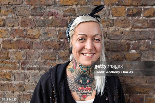 portrait of young woman with nose ring stud and tattoo - tattoo closeup stock pictures, royalty-free photos & images