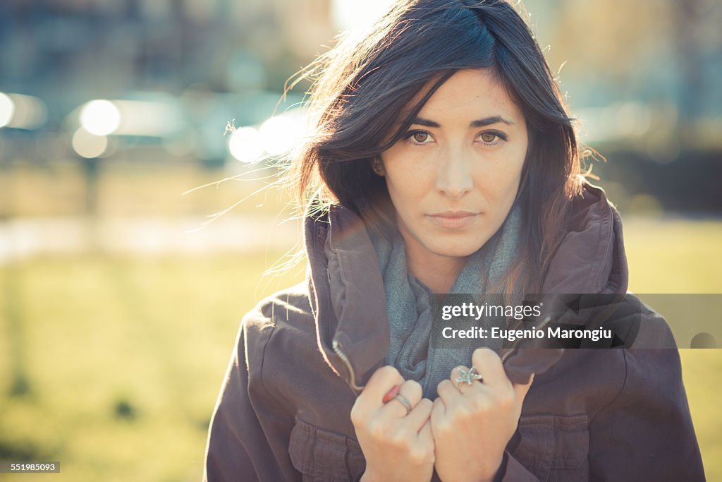 Portrait of mid adult woman holding collar in park