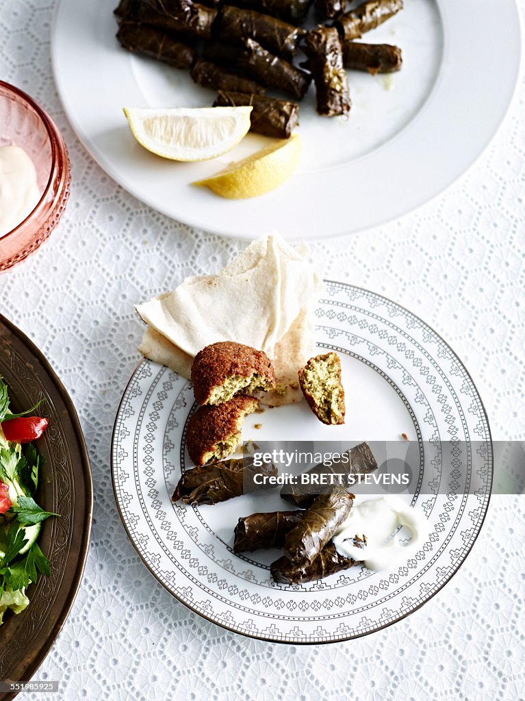 Still life with plate of slow cooked lamb in vine leaves