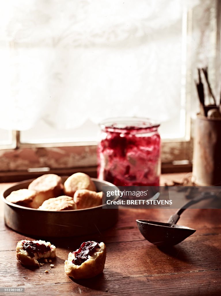 Rustic windowsill with rosella jam and puftaloons (fried scones)