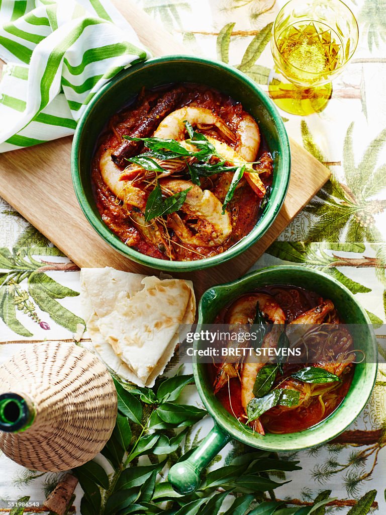 Casserole of prawns and garnish with glass of Indian coconut vinegar