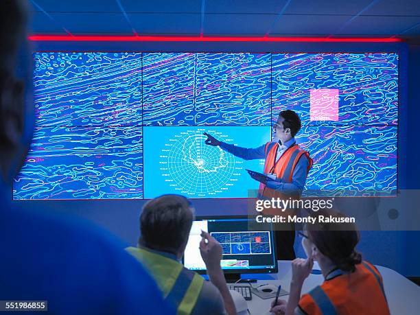 geologists studying graphical display of oil and gas bearing rock on screens - geologist stock pictures, royalty-free photos & images