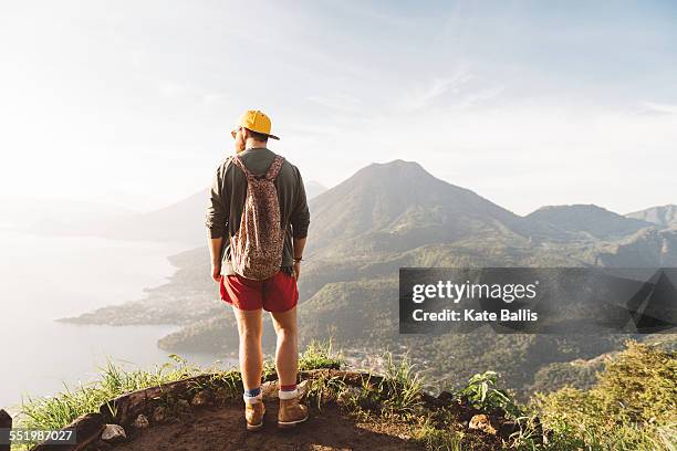 rear view of young man looking out over lake atitlan, guatemala - guatemala bildbanksfoton och bilder
