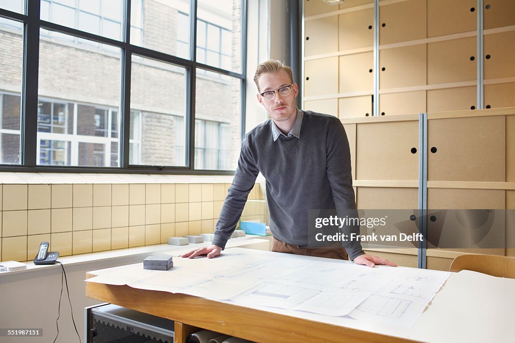 Portrait of young male designer in creative office