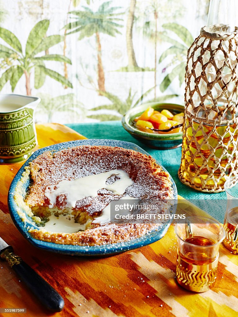 Bowl of cake and dairy cream with glass of white vinegar