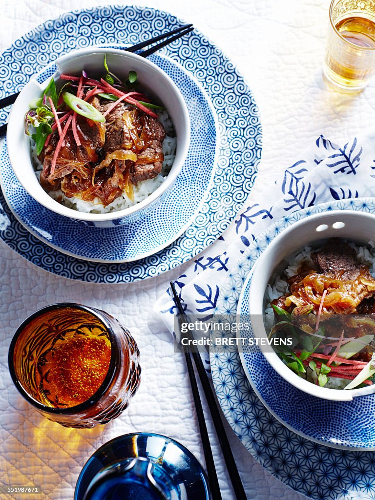 Bowls of curry with steamed rice and Japanese umeboshi vinegar