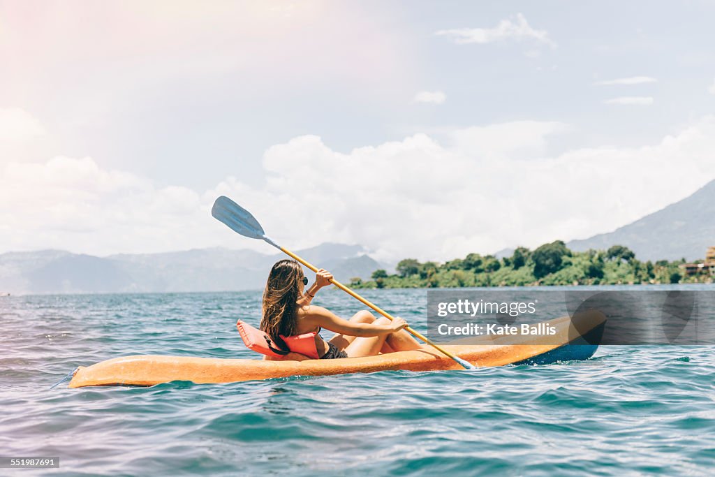 Young woman kayaking on Lake Atitlan, Guatemala