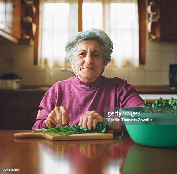 portrait of a serion woman - old person kitchen food stock-fotos und bilder