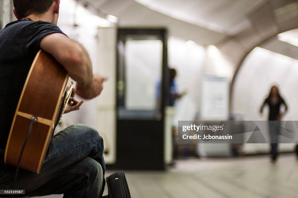 Man playing Guitar at the London Underground