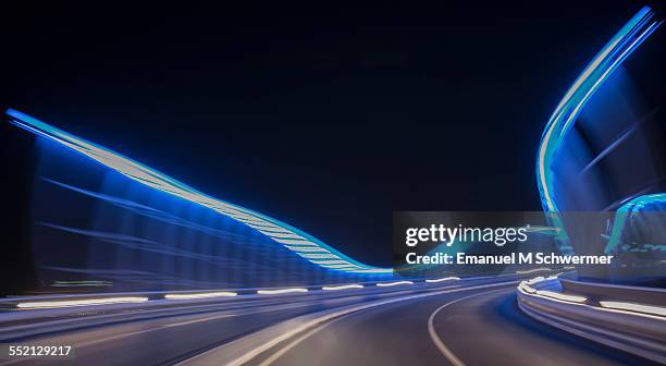 pov of a car / driving over illuminated bridge - dubai bridge stock pictures, royalty-free photos & images