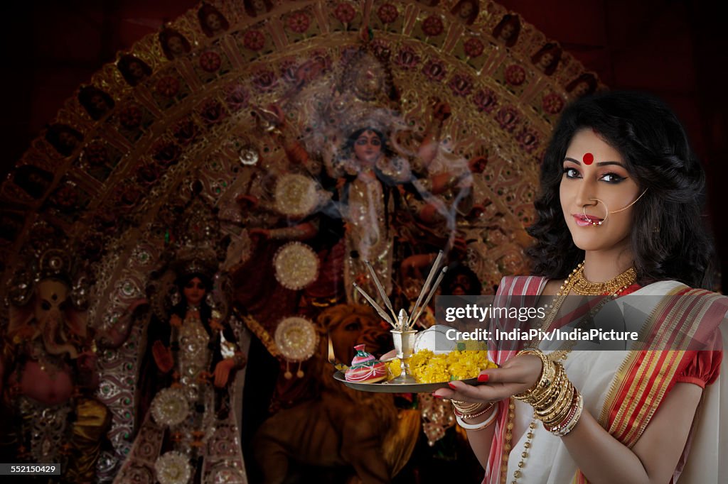 Portrait of Bengali woman holding a puja thali