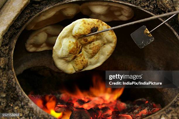 fresh tandoori roti baked in oven - tandoor oven stock pictures, royalty-free photos & images