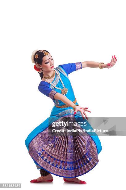 full length of beautiful woman performing bharatanatyam on white background - bharatanatyam dancing stock pictures, royalty-free photos & images