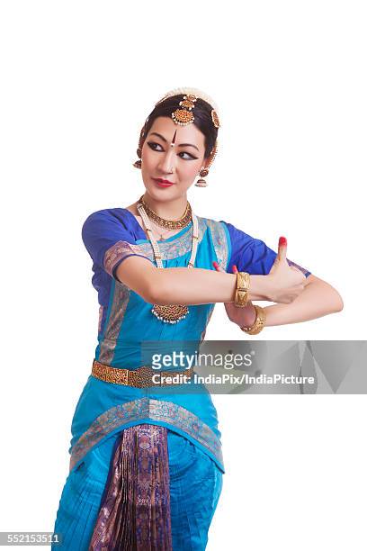 dancer performing bharatanatyam against white background - bharat natyam foto e immagini stock