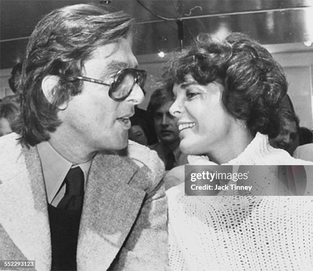 American film producer and executive Robert Evans talks with actress Ali MacGraw at an unidentified Fashion Week event, New York, New York, 1969.