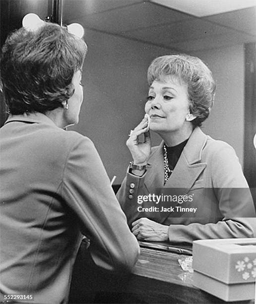 American actress Jane Wyman looks into a mirror as she applies make-up, Philadelphia, Pennsylvania, 1979.