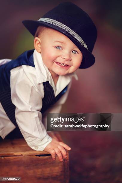 happy baby boy in suit and fedora hat - babies and smoking stock-fotos und bilder