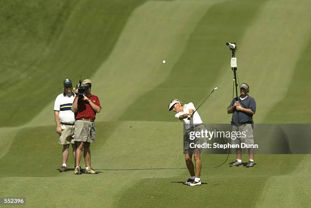 Liselotte Neumann hits a shot from the fairway in front of a television camera crew during the final round of the Kraft Nabisco Championship at...