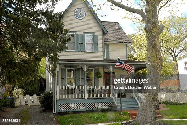 All American Victorian style home with American flags and old fashion porch in Mount Holly, New Jersey April 28, 2015