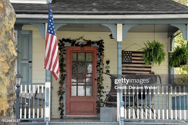 Victorian style home with a porch, two America flags in Mount Holly, New Jersey, April 28, 2015