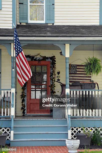 Victorian style home with a porch, two America flags in Mount Holly, New Jersey, April 28, 2015
