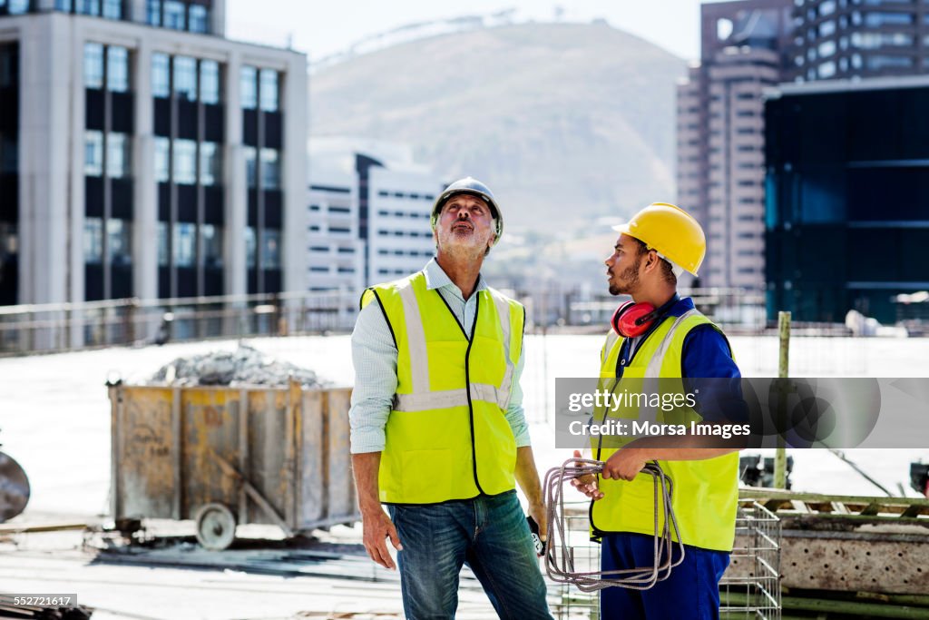Architect and worker working at site