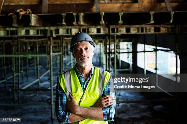 confident architect standing at construction site - construction worker stock pictures, royalty-free photos & images