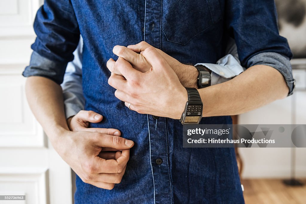 Gay Couple Hugging And Holding Hands