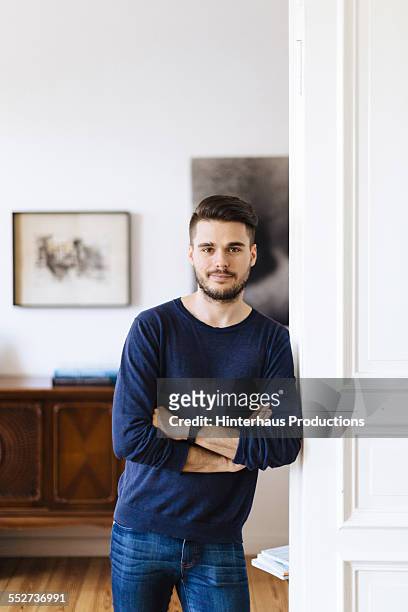 portrait of gay man in his apartment - beautiful gay men stock pictures, royalty-free photos & images