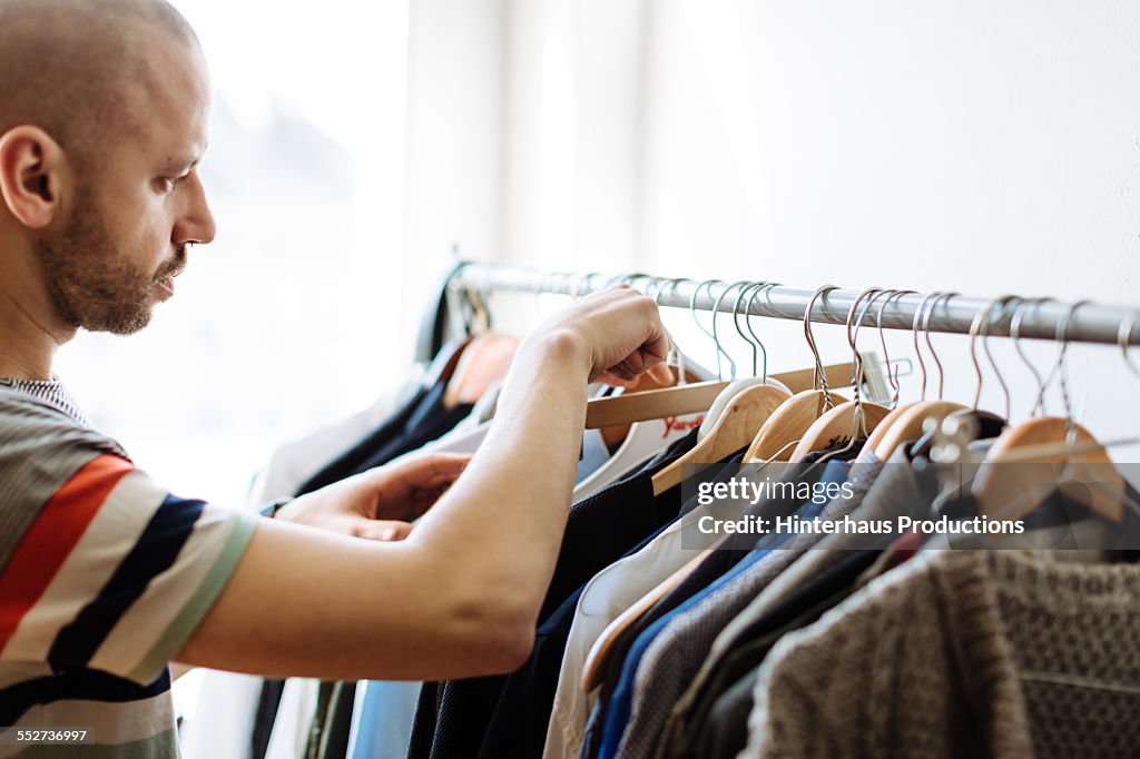 Gay Man Choosing Clothing For The Next Day