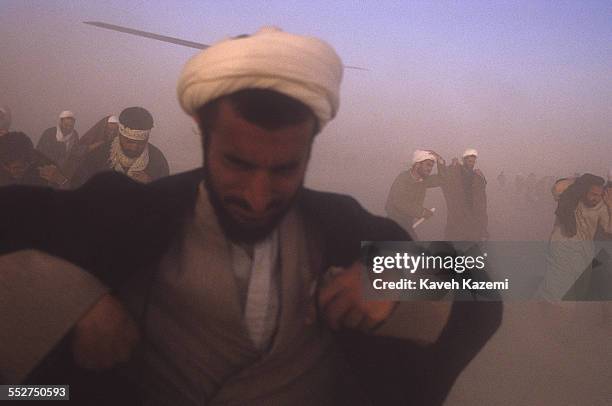 Clergymen arrive at a makeshift heliport before attending the funeral of Ayatollah Khomeini at Behesht Zahra cemetery, Tehran, Iran, 6th June 1989.